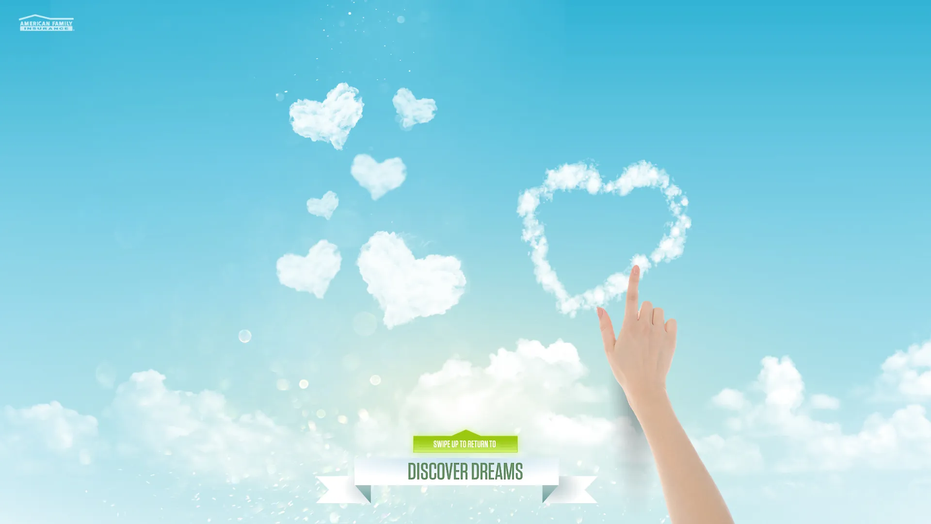 A hand drawing a heart-shaped cloud on the interactive DreamBank kiosk